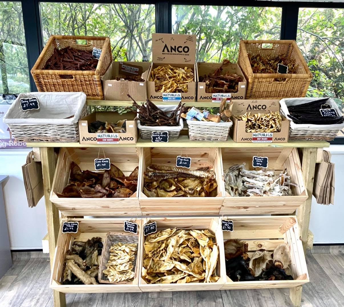 Natural dog treats on display in baskets and wooden crates in the Mighty Mutt House shop